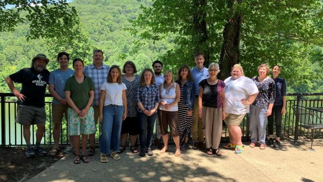 Outside members of the community university team assemble for a research and planning retreat.